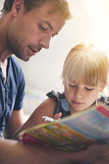 Dedicated to his daughter. Shot of a single dad helping his daughter with her homework.
