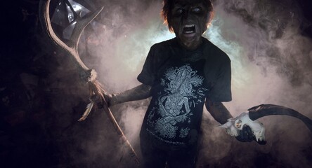 scary sorcerer in smoke. voodoo rite