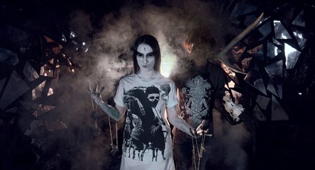 sorcerers stands in smoke. voodoo rite