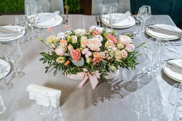 Flower arrangement in basket. Beautiful bouquet of mixed flowers on table.