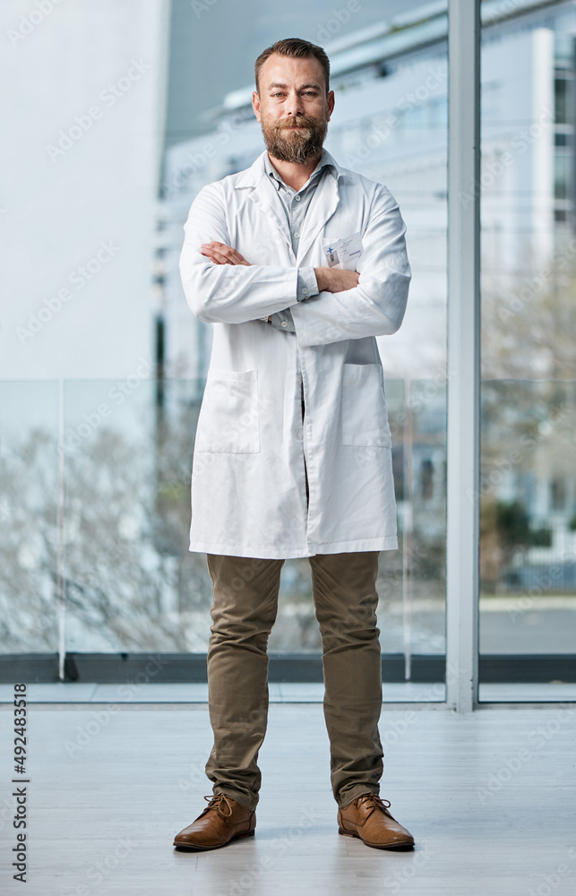 Poster Doctors form a strong pillar in the healthcare system. Portrait of a medical practitioner standing in a hospital.