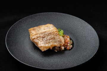 Delicious fish fry served on a beautiful plate, laid out on tartare.