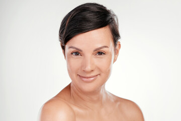 Confidence and beauty go hand in hand. Cropped portrait of a beautiful mature woman posing against a grey background in studio.