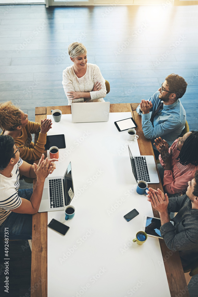 Poster sharing invaluable insights and ideas. high angle shot of a group of businesspeople having a meeting