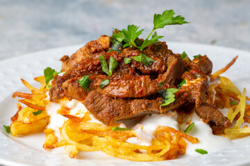 Turkish food; Cokertme Kebab - Beef meat kebab with yoghurt and french fries
