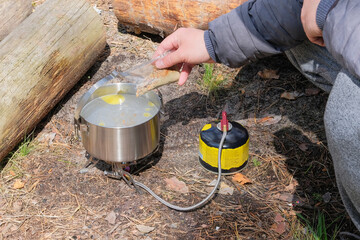 Camping food making. Tourist foods in outdoor activities. Food in bowler in the wild forest.