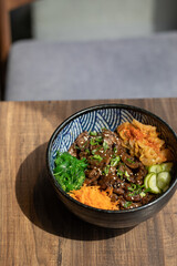 Poke bowls and other gourmet foods, with drinks and sushi on the table,
