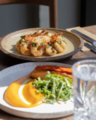 Poke bowls and other gourmet foods, with drinks and sushi on the table,