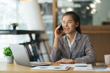 Close up Young Office Woman Talking to Someone on her Mobile Phone While Looking Into the Distance with Happy Facial Expression.
