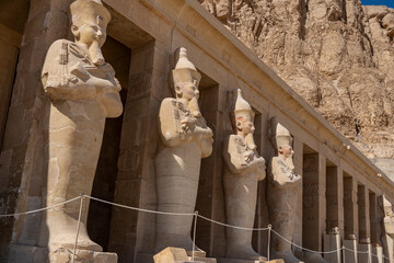 Funeral temple of Queen Hatshepsut in Luxor. Details. A row of statues of pharaohs stands along the...