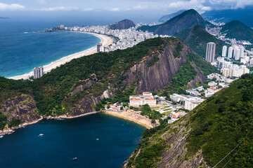Aerial view of Praia Vermelha, in the neighborhood of Urca in Rio de Janeiro, Brazil. The hills of Pão de Açúcar and Urca. Sunny day with some clouds at dawn. Barra da Tijuca on the background