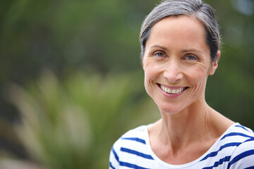 Content with her life. Cropped portrait of an attractive mature woman in casualwear standing...