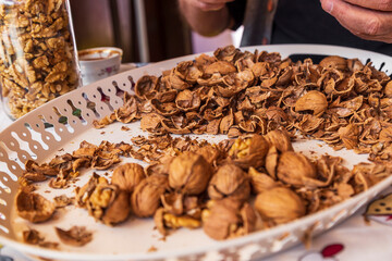 chopped walnut in a man's hand on white background