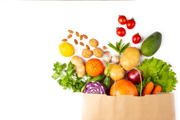 Healthy food background. Healthy vegetarian vegan food in paper bag vegetables and fruits on white,...