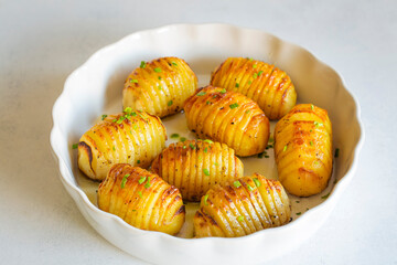 Hasselback potatoes with additional herbs and spices. In Turkey, fan potatoes are known as baked sliced potatoes. (Turkish name; firinda patates, yelpaze patates)