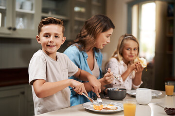 Its breakfast time. Cropped shot of a young family having breakfast at home.