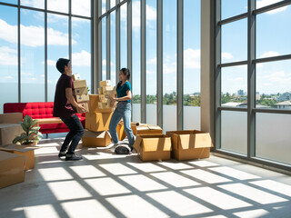 Asian young entrepreneur couple carry many postal boxes for send order to delivery man in modern home office