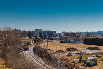Fototapeta premium Train station of Grosuplje in Slovenia is being renovated. Visible work train parked on a siding on a sunny day.