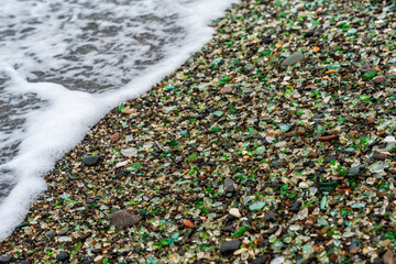 Glass Bay in Vladivostok. Sea-polished colored glass on the beach. Background, texture
