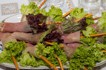 Original sandwiches with meat and greens on a plate