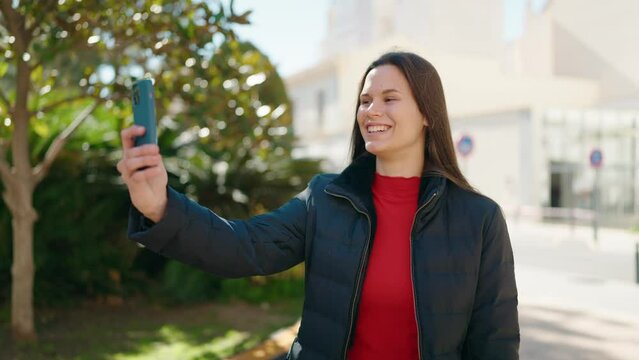 Young woman smiling confident having video call at park