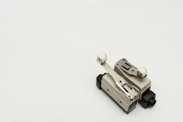 Limit switch sensor of the machine. Tiny limit switch for mechanical movement and actuators limits. isolated, white background of limit switch, control device, electrical equipment in control system.