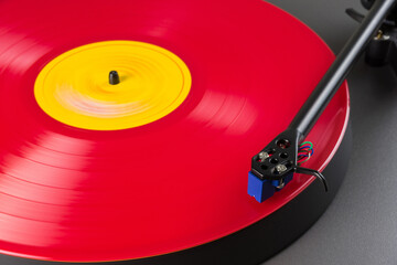 Turntable playing the colorful vinyl record close up