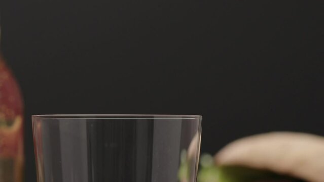 Slow motion apple cider poured into tumbler glass