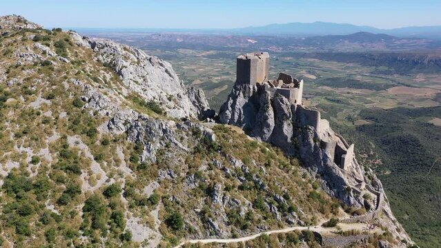 Picturesque rocky landscape overlooking medieval ruined castle Chateau de Queribus in summer, commune of Cucugnan, France