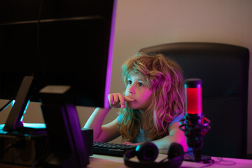 Little child blogger. A pretty child learns a lesson using a desktop computer at home. Home education.