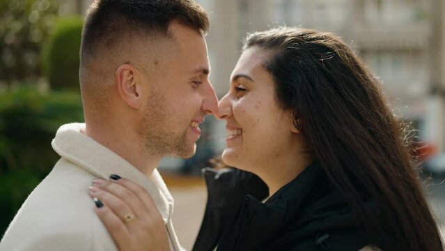 Young couple smiling confident hugging each other standing at park
