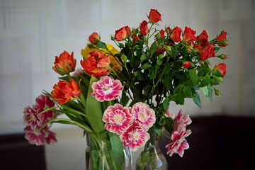 beautiful tulips and roses in a vase. spring flowers