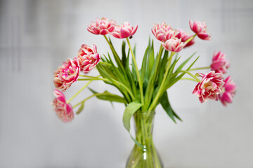 beautiful tulips and roses in a vase. spring flowers