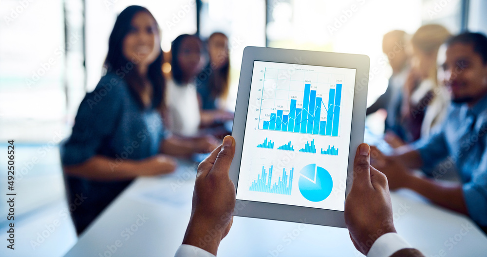 Poster his team is going to love these numbers. shot of an unidentifiable businessman holding up a tablet w