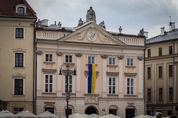 09-03-2022. krakow-poland. Buildings in the main square of Krakow - Rynek Gł&oacute;wny. Presenting the Ukrainian flag as identification with the Ukrainians in the Russo-Ukrainian War