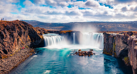 Soft waters of Godafoss - spectacular waterfall plunging over a curved, 12m-high precipice, with paths to various viewpoints. Bright summer view of Skjalfandafljot river, Iceland, Europe.