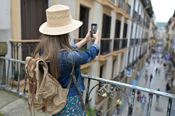 Yount toutist woman taking picture during city tour in Europe