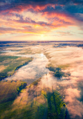 Astonishing summer scene of Ukrainian countryside, Ternopil region. Stunning morning view from flying drone of Angelivka lake. Foggy sunrise on Ukraine, Europe. Traveling concept background.