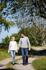 Its a perfect day for love. Full length shot of a young couple walking hand in hand in a park.