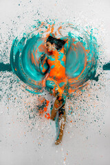 top view to expressive sexy naked woman lying elegant on the floor in turquoise blue orange color abstractly painted bodypainting woman on the splashed ground © ullision
