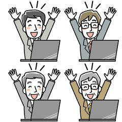 パソコンの前でバンザイをするビジネスマン