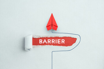 Concept of overcoming barriers, goal, target. Red paper plane © Worawut