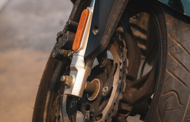 Closeup disc brake of motorcycle. Motorbike accessory. Aluminum alloy wheel of dirty motorcycle....