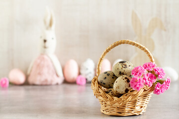 Easter background with colorful mini eggs, flowers and bunnies
