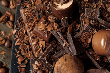 Grated chocolate and pieces of tasty chocolate on table