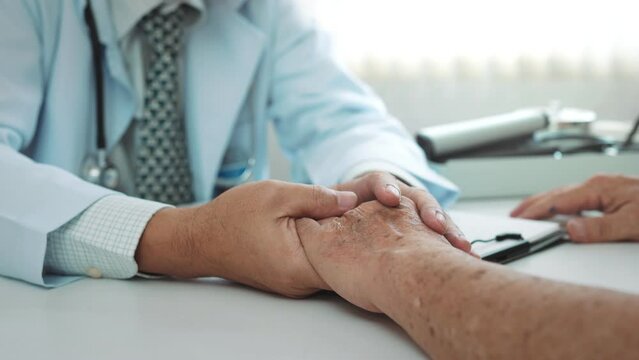 B roll - Man doctor holding hands of senior grandfather patient help express empathy encourage tell diagnosis at medical visit, Elderly people health care, Older people healthcare support concept.