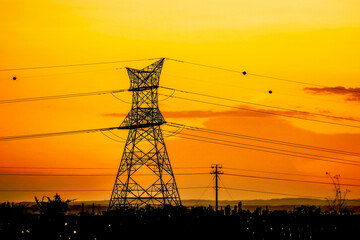 Power lines against a radiant sunset in rural Kenya