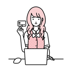 デスクで座ってPCを使いながらクレジットカードを手に持っている事務員制服の女性