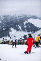 Slovakia, Jasna - February 4, 2022: winter mountains view ski resort slopes people skiing and snowboarding