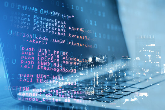Close up of laptop with abstract html code on creative city background. Coding and programming concept. Double exposure.